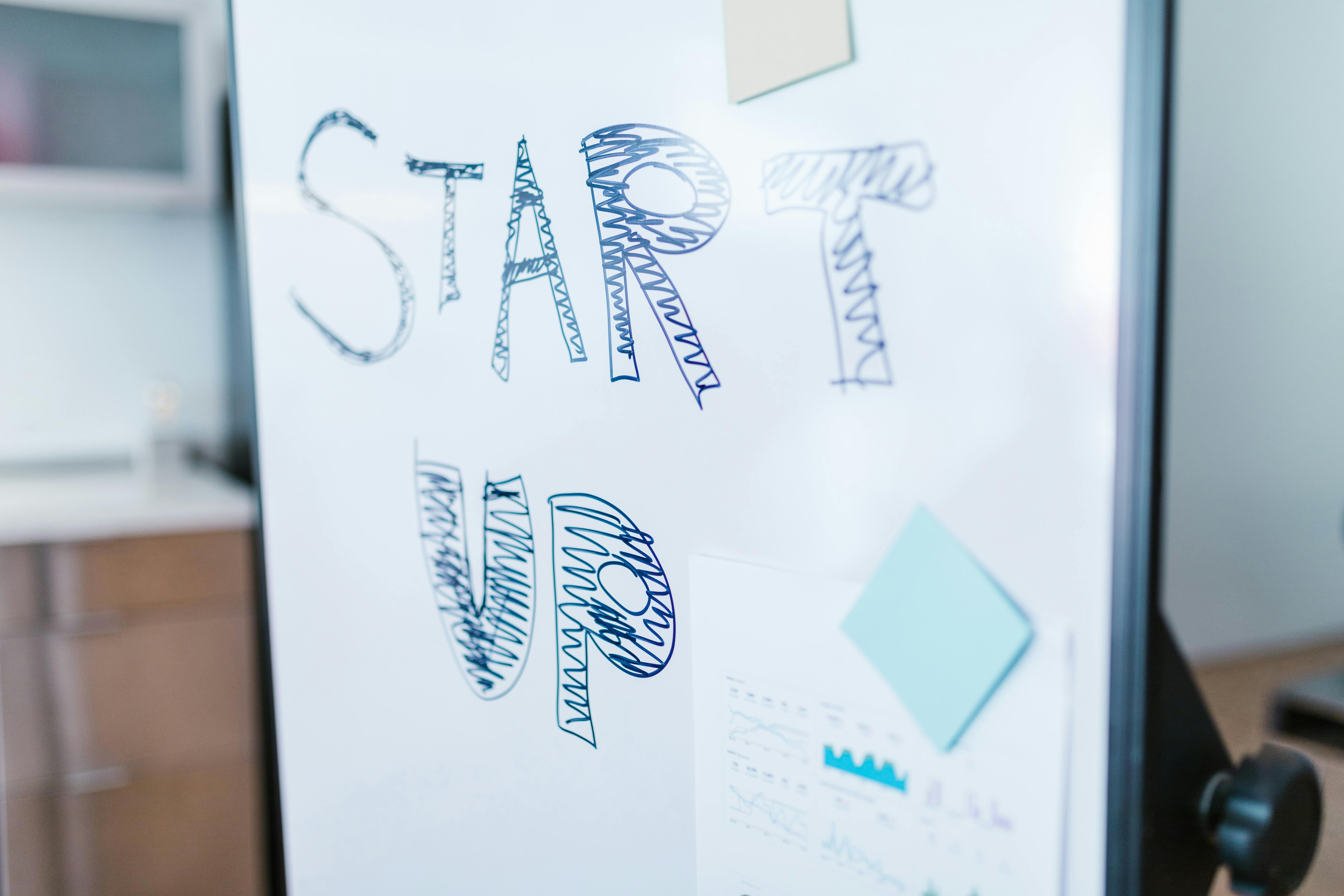 Creative startup concept handwritten on a whiteboard, symbolizing innovation in business.